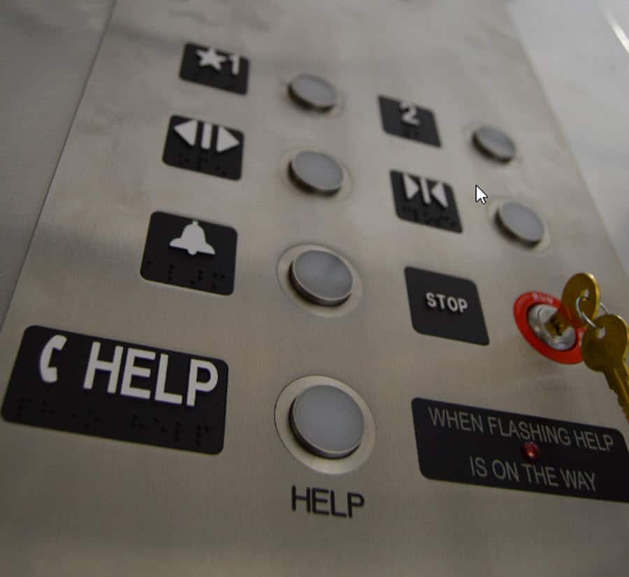 Negative interest rates symbolized by upward view of elevator buttons. The word "HELP" is prominent at  bottom.