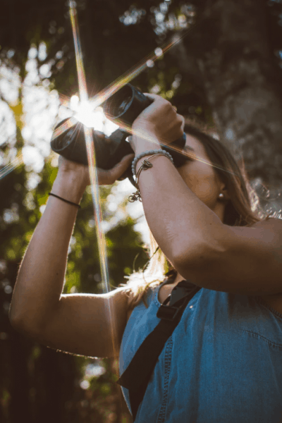 woman using binoculars, symbolizing our 3-part test for stocks