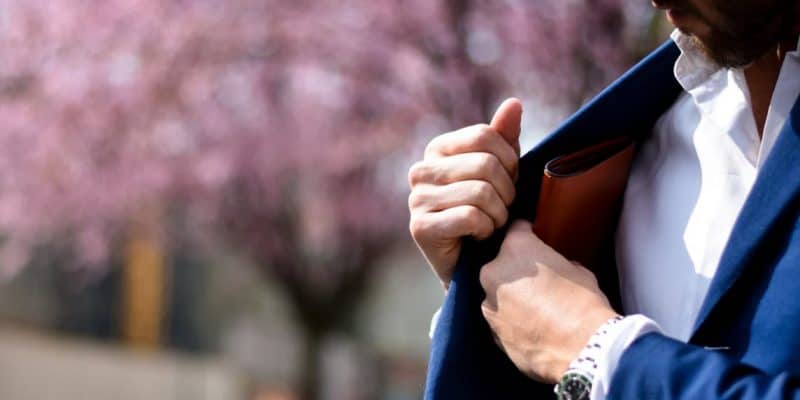 man reaching for billfold, symbolizing What Does It Cost?