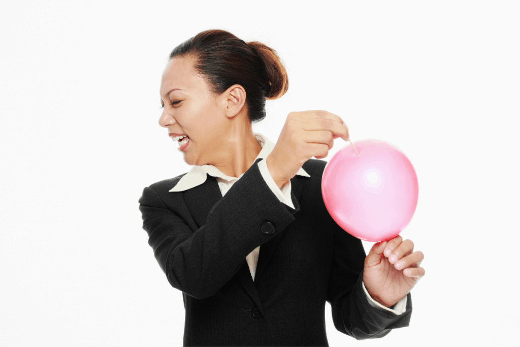 woman looking away anxiously as she is about to pop balloon. Symbolizes title of post, The Souffle and The Sledgehammer