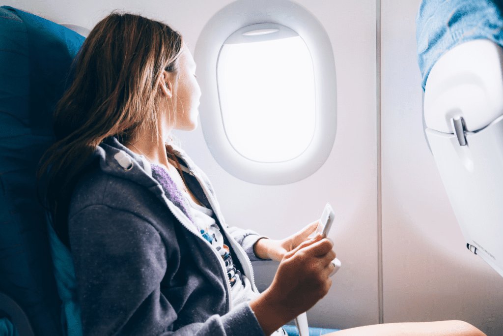 Woman looking out airplane window